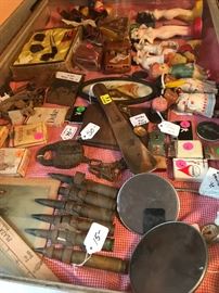 Celluloid Dolls, WWII shells, Vintage vehicle mirrors (one has a thermometer on it!), Zippo lighters, Chalk-ware carnival nudes, Medco Pipe boxed set, vintage cigarettes still in their packaging, A Railroad switch lock w/chain, and much more!  