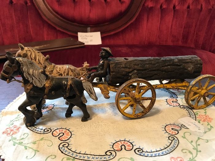 The Black Memorabilia Driver of this log wagon, complete with a cast-iron log, was made by Kenton Toys.  