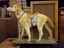 French paper mache dog on metal wheels