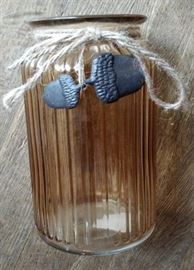 Pretty amber glass jar with acorn accent.