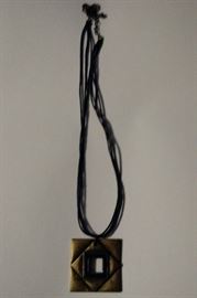 Bronze and dark blue pendant on cord
