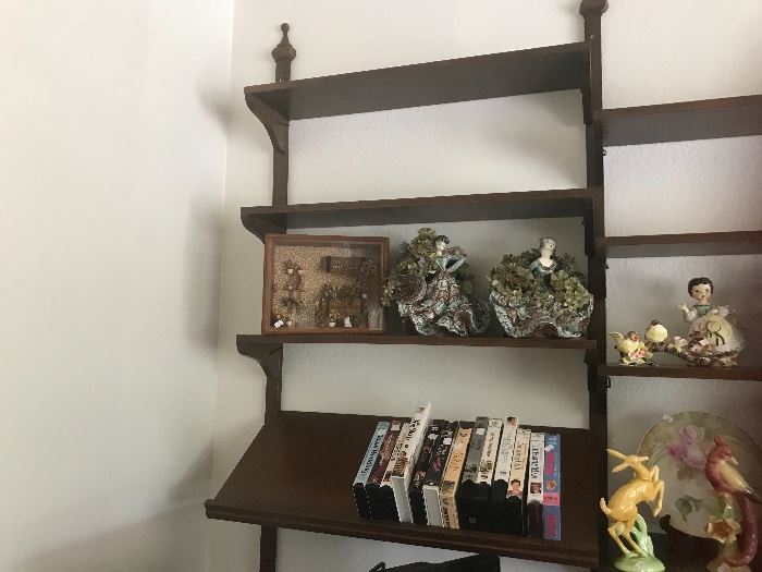 Arizona room has a wall of shelves with contain VHS tapes and various figurines.  The 2 on the left I believe are Italian.