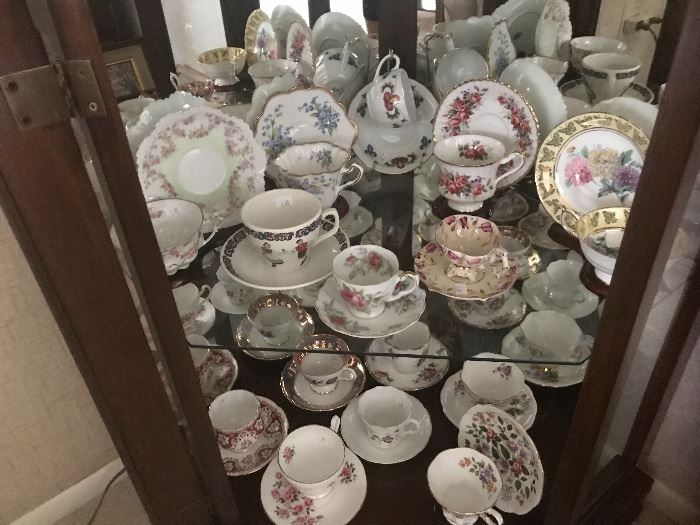 Tea cups in curio cabinet in living room.  Yes the curio is available for sale, but we ask that you pick it up after the sale, as we have no place else to display all these goodies.