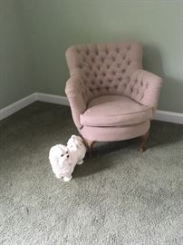 Pink child’s chair.  Dog.