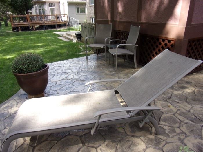 Patio lounge chair and two patio armchairs with side table. Large plastic planter with beautiful flowers (2).