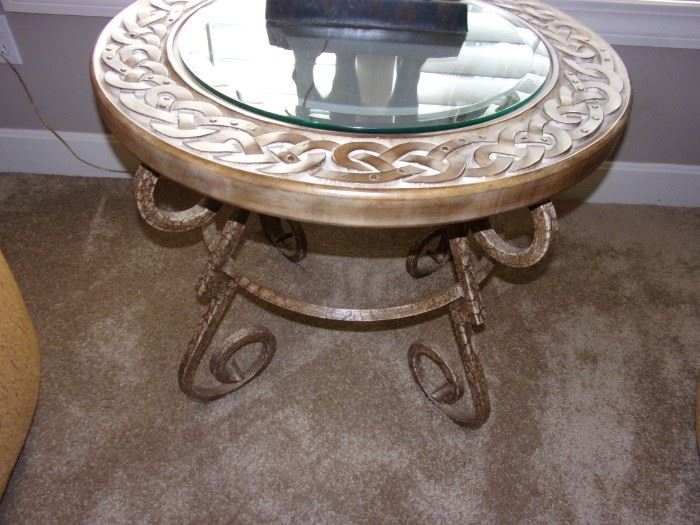 Iron base round table with glass center.