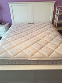 Queen Chiropractor's Care mattress and box spring and white Queen bed frame.