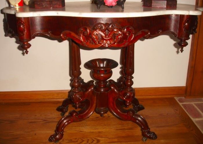 21 - CENTER TABLE - Mid 1800's, rosewood with marble turtle shaped top, base with scrolls, scrolled legs, stylized paw feet on casters.