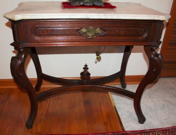 1 SIDE TABLE  Circa 1860, walnut, canted marble top, sincle frieze drawer, cabriole legs, stretcher with urn shaped finial.