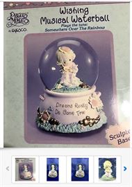 Several water globes are available, of varying ages, sizes, manufacturers, styles, condition, and prices; The item shown is a Precious Moments "Dreams Really Do Come True" that plays Somewhere Over the Rainbow, priced at $20