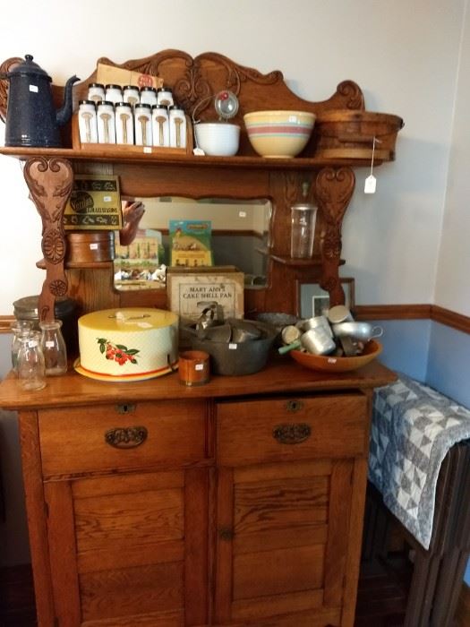 Oak sideboard with vintage kitchen utensils.