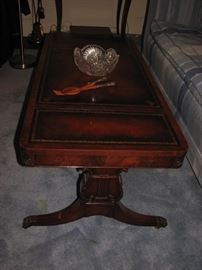 Duncan Phyfe leather top sectional coffee table with lyre cut into legs.