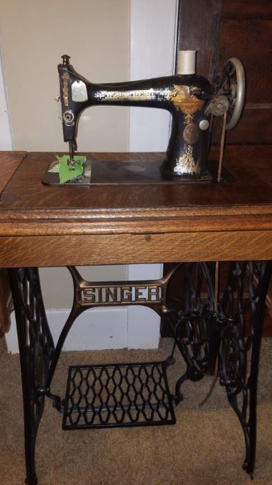 antique treadle Singer sewing machine. very nice condition with Tiger Oak cabinet