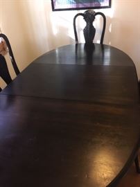 Dining table has one leaf, 4 chairs.  72” x 39”