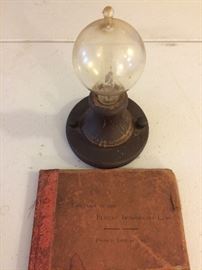 One of the first lightbulbs made. With book