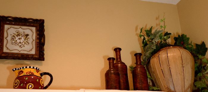 Really neat urn and bottles along with a pretty colored pitcher and more wall decor for sale in this super clean home.