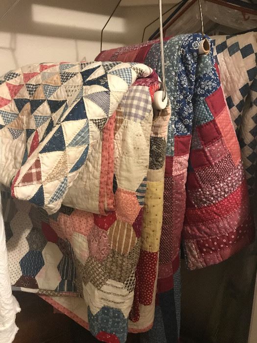 Various hand stitched quilts.