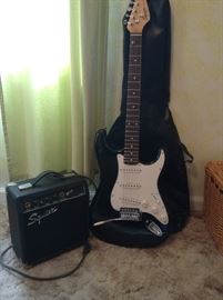 Fender Squier Strat 6 string and Squier amplifier, comes with cords, tuner, book, picks and extra strings