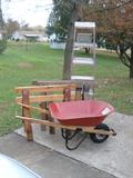 A Radio Flyer model 82 yard barrel with saw horses and 6 foot step ladder.