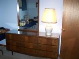 There are 9 drawers in this walnut all wood dresser with a glass top and attached mirror. The dresser is retro with legs it's 62" long & 18" deep & 30' tall, the mirror is 4x29 very nice.