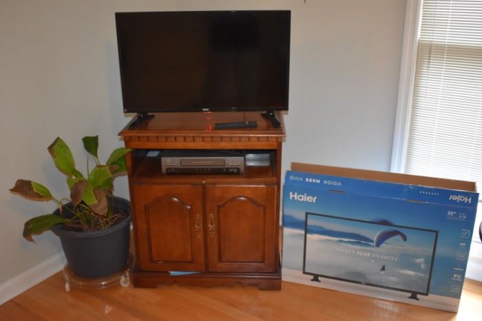 Flatscreen Haier TV, VCR, and Beautiful Double Door Cabinet