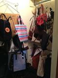 lots of purses and bags plus Hartmann luggage