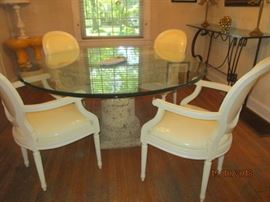 Large dining room table with lava stone type base and 4 vintage chairs