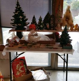 Vintage ceramic Christmas trees, unused Gurley jack-o-lantern candle with candle inside, Large white bottle brush musical Christmas tree in box, feather tree,feather wreath, unopened vintage paper tablecloths and napkins, Hallmark honeycomb centerpieces.