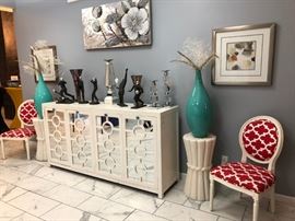 Elegant Artwork, colorful accent pieces and a large Mid-Century cabinet