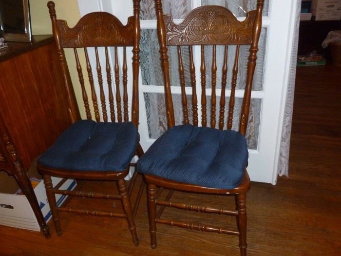There are 4 of these pressed back chairs