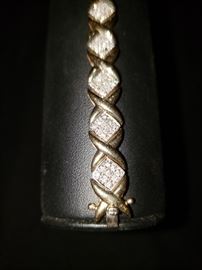 10K gold and diamond bracelet. This piece does have one missing stone. 