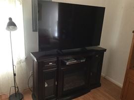 Sony 60" Flat Screen TV on storage media cabinet with center electric fireplace