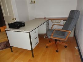 Office desk with small filing cabinet and upholstered office chair