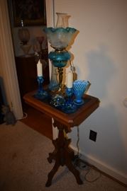 All of these Exquisite Banquet Lamps are very rare and sought after, this one as with the others in this Estate, is no exception Also displayed is a Victorian Table, Blue Moonstone Glass Vase and other Collectibles.