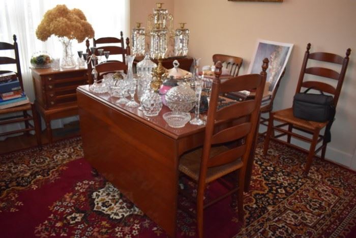 Beautiful Drop Leaf Dining Table with Matching Rush Seated Ladder Back Chairs. The table is loaded with Collectible Glassware and a Gorgeous Crystal Candelabra. Look at the Colors in this Persian Rug