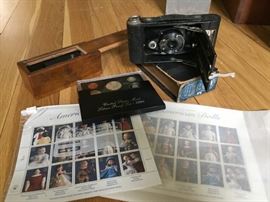 Stamps and Coins and Polaroid Camera.