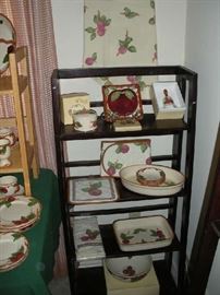 Kitchen:  In 1983, the production of FRANCISCAN-WARE  was shifted to England.  This stand displays pieces manufactured in England and Portugal:  covered dishes, bowls and casseroles.  Also shown are a couple of apple-theme items, including a tablecloth hanging on the wall.