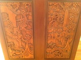 Living Room: This is a closer photo of two of the four carved panels on the bar.