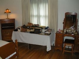 Bedroom #1 (Master): The opposite side of the room has a matching BURNS maple secretary and vanity.  In the middle is a table with numerous purses, stockings and miscellaneous.  Closer photos of the secretary and vanity follow.