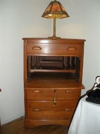 Bedroom #1 (Master):  The vintage BURNS secretary is open to reveal the interior.  On top of the secretary is a vintage slag glass panel lamp by EM & Co. (1161).