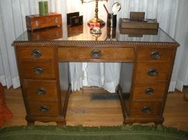 Bedroom #4:  The vintage knee hole desk has a custom glass top.  It is in very good condition!
