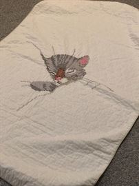 Child’s quilt with cross stitch kitten.