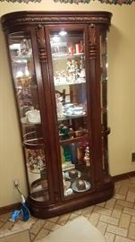 Five-shelf mirrored back lighted bow-front curio cabinet
