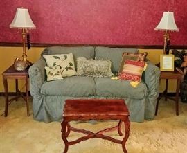 loveseat with slipcover, end tables, sm coffee table, lamp pair, throw pillows, & decor -- SITTING ROOM
