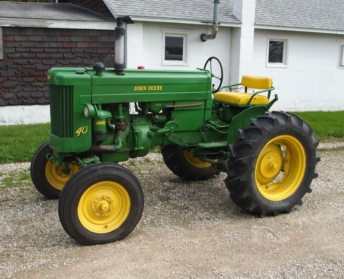 A 1952 John Deere Model 40 Tractor with plow.  Older restoration, complete and running, includes a vintage single bottom plow. 