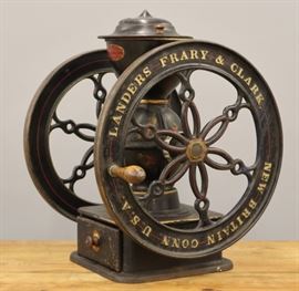 A late 19th century Landers, Frary, & Clark Coffee Grinder.  Counter top model in painted cast iron with remnants of stencil decoration, turned wood handle, and painted wood drawer, and turned wood knobs.  Marked "Crown Coffee Mill Made by Landers, Frary, & Clark New Britain Conn. U.S.A." along with "90" on the cover.  Wear and some losses to the paint and decoration.  25 1/2" high.  