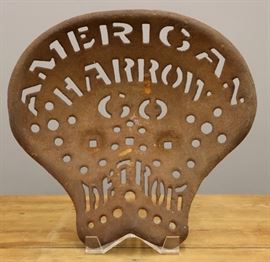 A late 19th century American Harrow Co. (Detroit) cast iron Tractor Seat.  Wear, surface rust.  14 1/4" long.  15 5/8" w x 14 3/8" d.