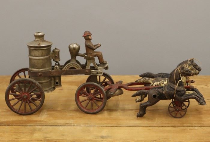 A 19th century Cast Iron Toy Horse Drawn Fire Pumper.  Includes three horses and a driver; unmarked.  Significant wear, little remaining paint, wagon body with repair.    18" long.