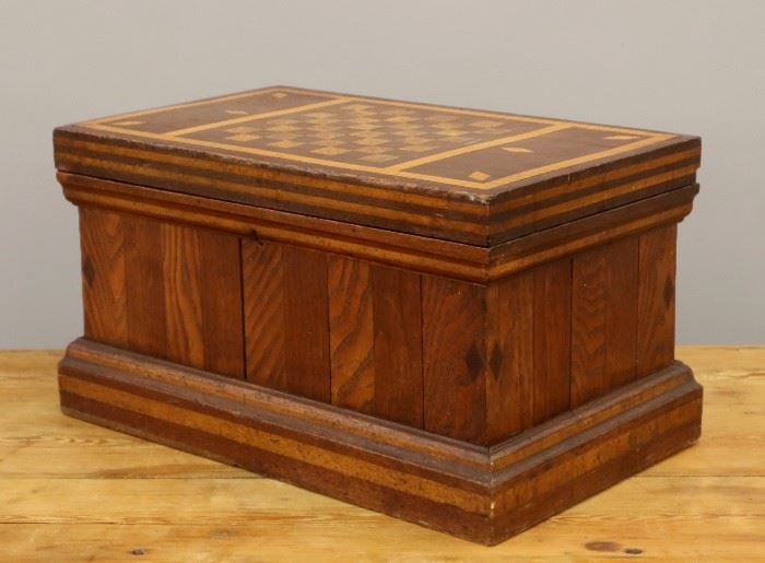 A turn of the century Wooden Games Box.  Rectangular box with hinged cover made of Walnut, Ash and Maple.  Marked "Charles H. Taddai -  Keep Out" on top edge.  Wear and minor damage.  20 1/8" x 10 7/8" high.