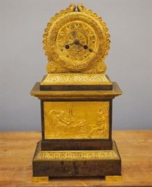 An early 19th century French Bronze Empire Period mantle clock.  8-day time and strike movement with engine turned dial and silk thread suspension.  Two tone Bronze case with acanthus leaf and floral detail, lower tablet with Old Man Time.  Some case wear particularly to the Brown patinated areas, movement appears to be complete but lacks pendulum.  17 1/2" high.